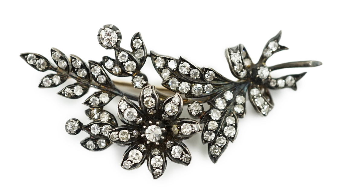 A late Victorian gold, silver and diamond cluster set trembleuse floral spray brooch